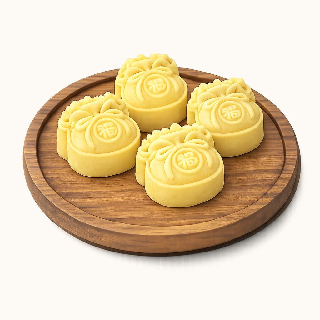 Four yellow flower-shaped mooncakes arranged on a round wooden plate, photographed on a clean off-white background.