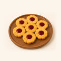 Seven flower-shaped cookies with golden-yellow petals and dark red centers, arranged on a round wooden plate against a solid cream background.