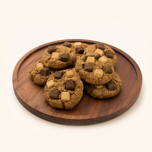 Five chocolate chip cookies with dark and milk chocolate chunks, arranged on a round wooden serving board against a clean off-white background.